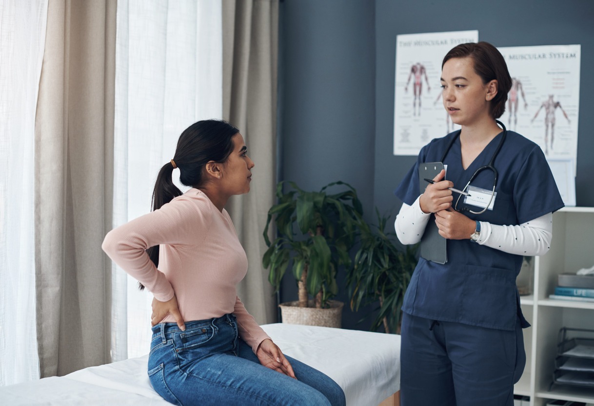 My lower abdomen hurts the most. a young female patient talking to a doctor in their office. 