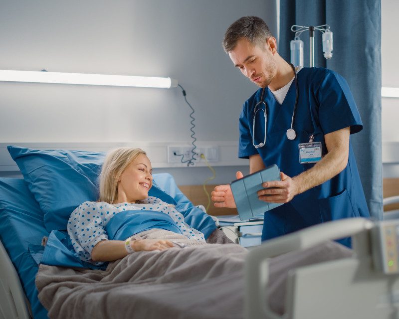 Physician Uses Tablet Computer, Shares to a Patient, Woman Recovering after Successful Surgery