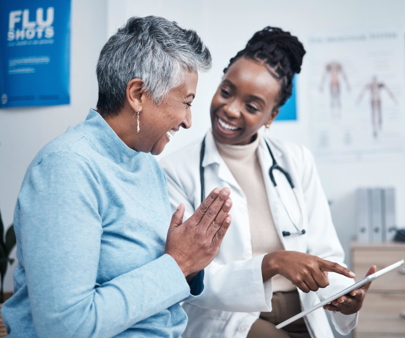 Female doctor and elderly patient with good news, tablet and results for health, advice and report.