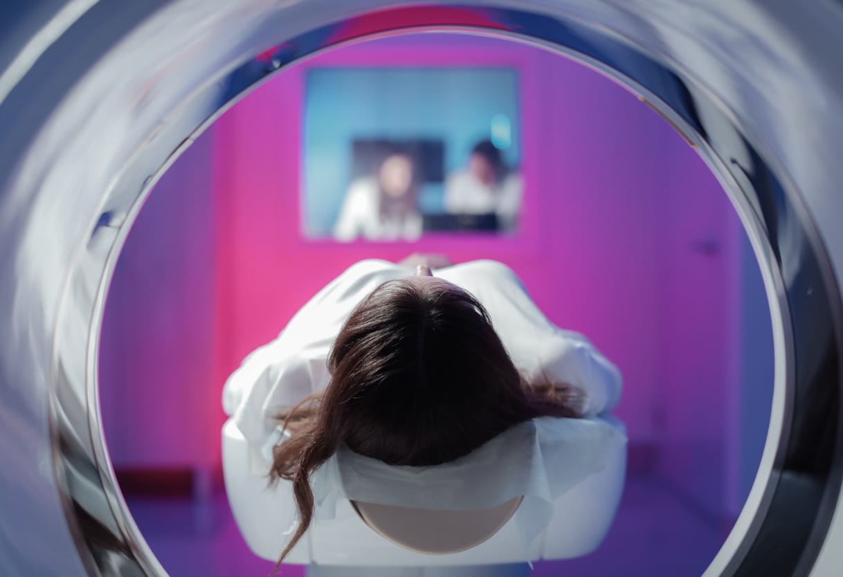 The girl patient is lying in the MRI and waiting for a scan. 