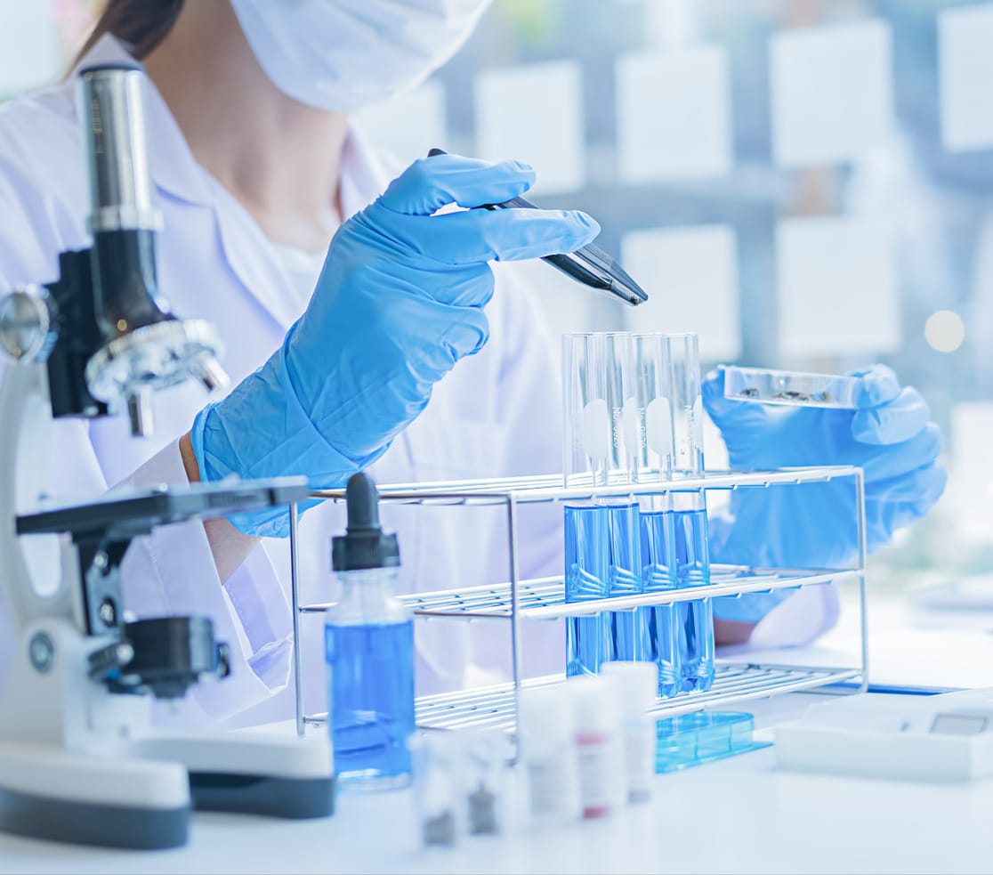 Medical or scientific researcher or man doctor looking at a test tube of clear solution in a laboratory 