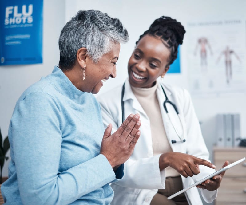 Female doctor and elderly patient with good news, tablet and results for health, advice and report.