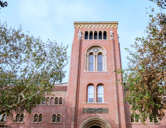 A gorgeous and prestigious brick tower and building on the USC college campus.