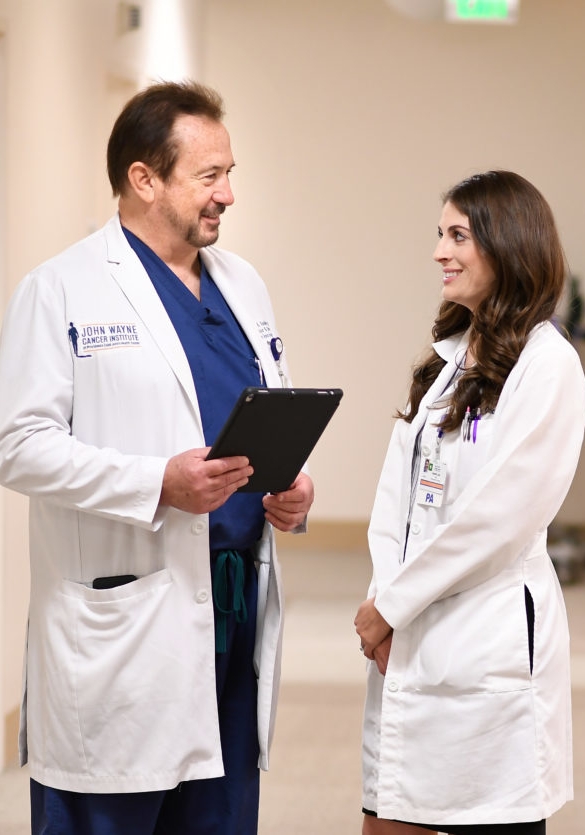 Dr. Vasilev speaking with Lisa Stern in physicians attire at the hospital